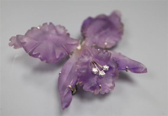 A modern white metal and diamond mounted carved amethyst flower head brooch, width 62mm.